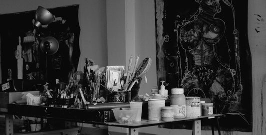 A picture of a art studio representing 2 large artworks on the wall